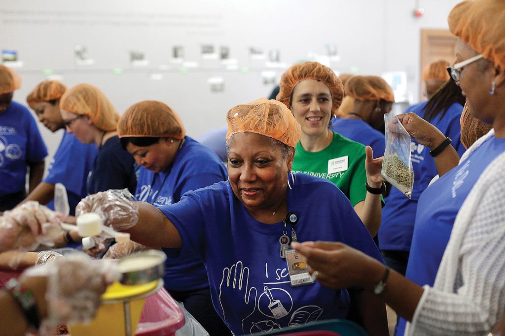 Teams from Roosevelt and from BlueCross BlueShield of Illinois put together meals for the homeless. 