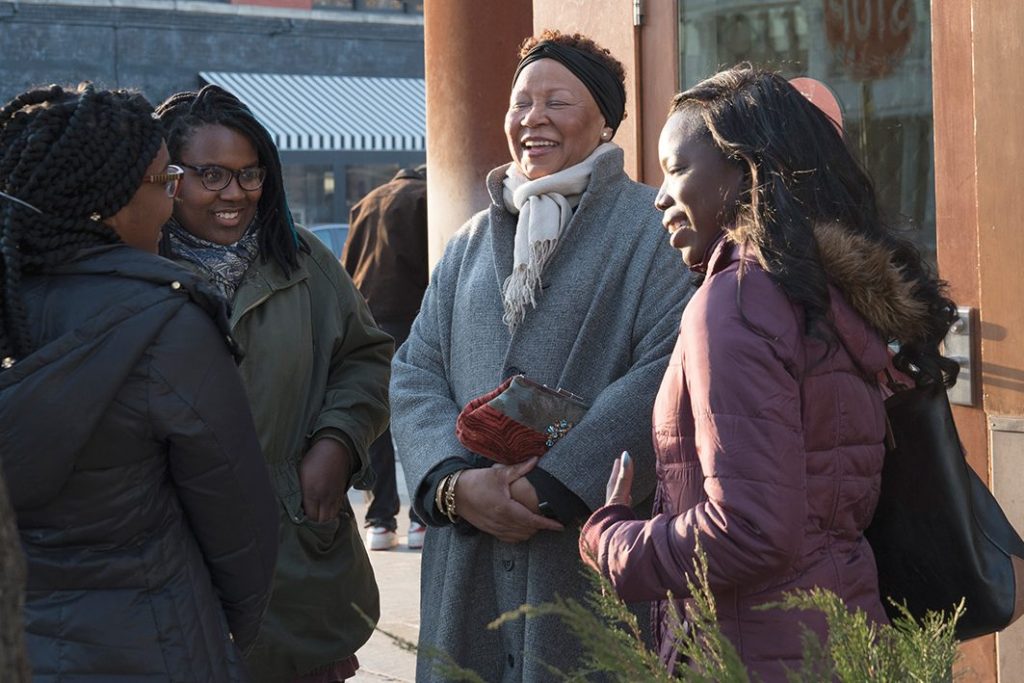 Pat Harris laughs with mentees (left to right) Carlita Kelly, Ta’ Tee-Etta McBride and Tierra Jackson. 