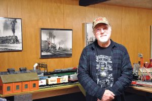 Paul Weritco posing with train collection