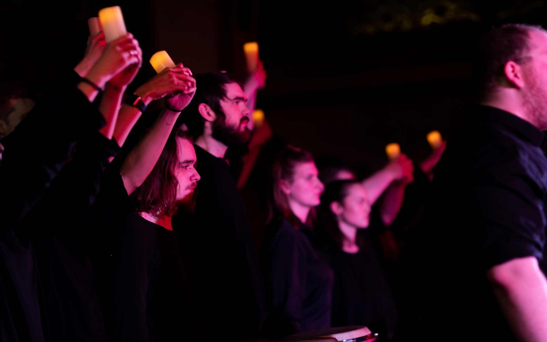 CCPA student performers hold candles during a performance of Considering Matthew Shepard.