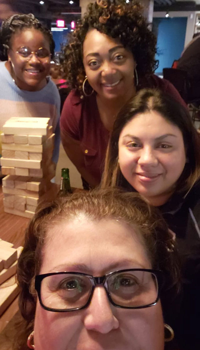 McNair students and staff playing a game of Jenga