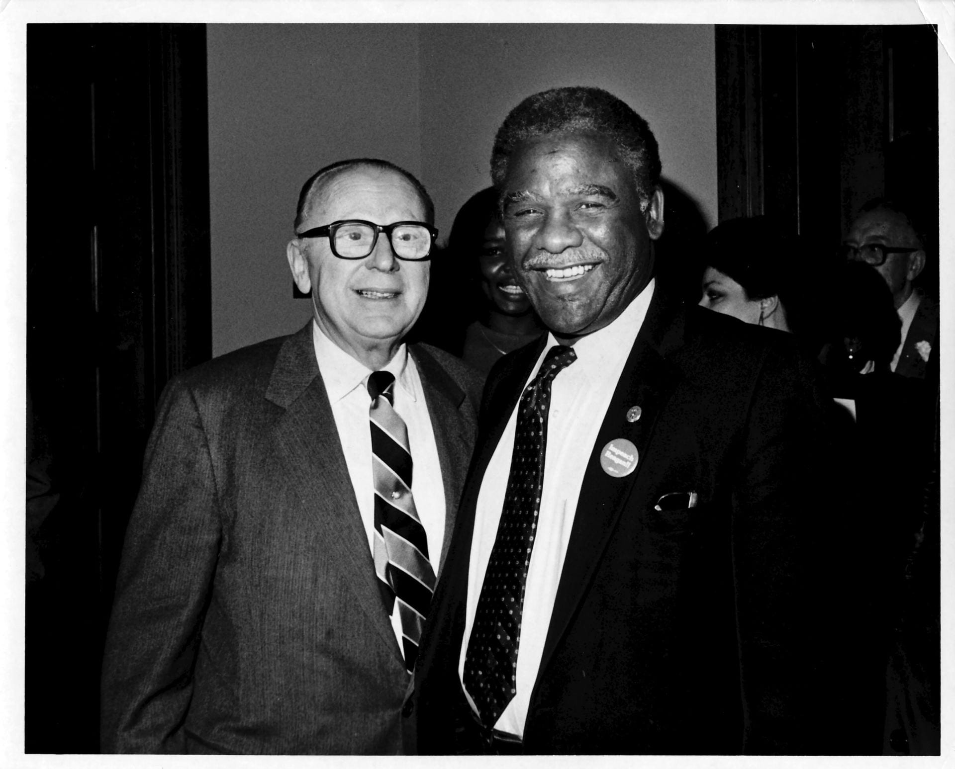 Mayor Harold Washington (right), wearing an Impeach Reagan button, poses with Roosevelt president Rolf Weil.