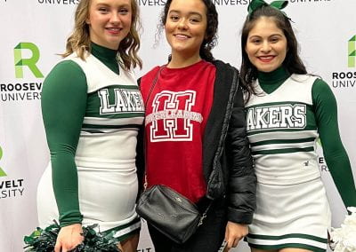 An incoming Roosevelt student smiles with two cheerleaders on Admitted Students Day. Over a hundred admitted students and their families flocked to the Goodman Center to learn more about the Roosevelt experience.