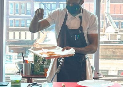 Chef Travis Lewis dishes up some mouthwatering soul food during a Black History Month cooking demonstration. Lewis earned his culinary arts degree from Robert Morris University Illinois.