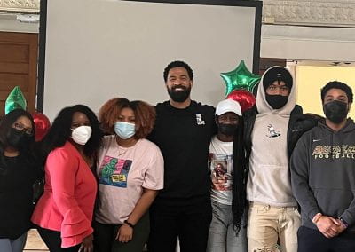 Students pose with guest speaker Spencer Paysinger (center) after his Black History Month keynote speech. Paysinger is a former NFL athlete whose story was adapted in the hit CW show All-American.